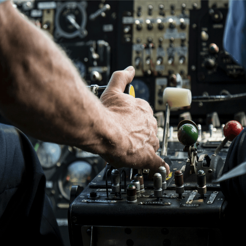 Close-up of an aircraft control panel being used during flight